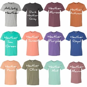 May include: Twelve different colored t-shirts with heather textures. The t-shirts are arranged in a grid of four rows and three columns. The colors are: Athletic Heather, Dark Heather Grey, Heather Maroon, Heather Autumn, Heather Sea Green, Heather Sunset, Heather Purple, Heather Royal, Heather Peach, Heather Olive, Heather Mint, and Heather Mauve.