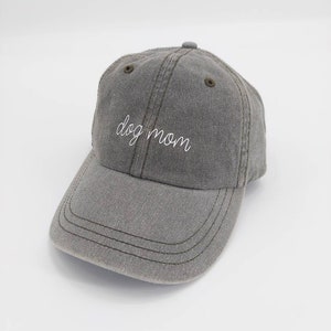 Puede incluir: Una gorra de b&eacute;isbol gris con el texto "dog mom" bordado en blanco en la parte delantera.