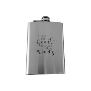 May include: A silver stainless steel flask with the quote "It takes a big heart to shape little minds" engraved on the front.
