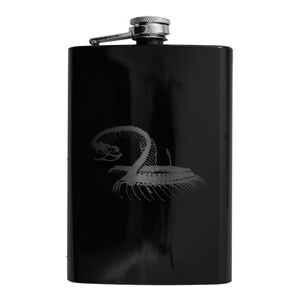 May include: Black stainless steel flask with a silver cap and a white skeleton snake design.