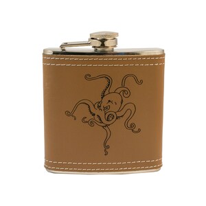 May include: A brown leather-covered flask with a silver top and a black octopus design.