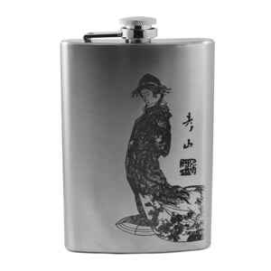 May include: A silver flask with a black and white image of a woman in a traditional Japanese kimono. The flask has the Japanese characters "小鳥" engraved on it.