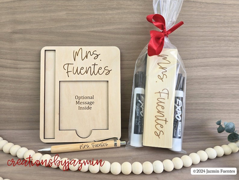 May include: A teacher gift set with a wooden picture frame, a pen, and a gift bag containing dry-erase markers and a wooden sign, all engraved with "Mrs. Fuentes". The frame has space for an optional message.
