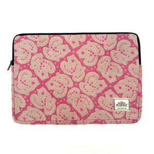 May include: Pink laptop sleeve with a white floral pattern and the text "The Bombay Store" in a white rectangle.