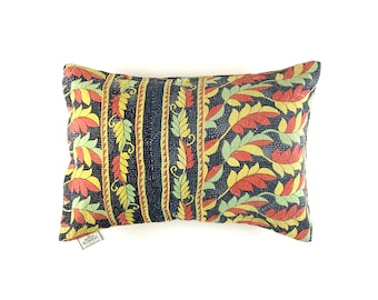 May include: A black and yellow patterned pillow with red and green accents. The pillow is made of kantha fabric and has a unique, hand-stitched design.