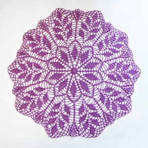 Puede incluir: Un encaje de ganchillo morado con un delicado patr&oacute;n floral.