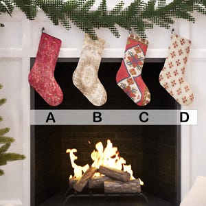 Set of 4 handmade vintage-style Christmas stockings, including red, beige floral, and a traditional red and blue Turkish kilim print, hanging on a fireplace mantel.