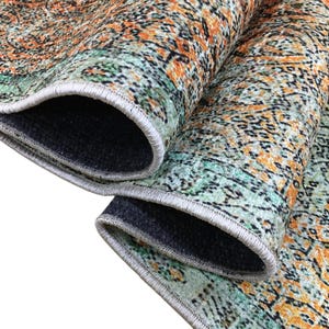 a close-up view of a colorful, patterned rug with a mix of orange, green, and black colors. The rug appears to be made of a soft, plush material and has a textured surface.