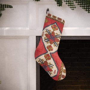 Set of 4 handmade vintage-style Christmas stockings, including red, beige floral, and a traditional red and blue Turkish kilim print, hanging on a fireplace mantel.