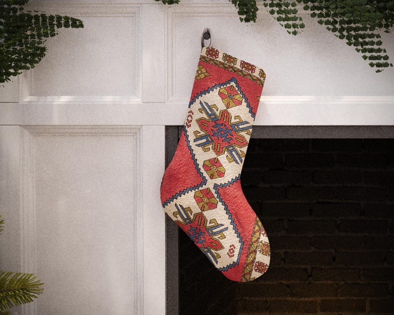 Set of 4 handmade vintage-style Christmas stockings, including red, beige floral, and a traditional red and blue Turkish kilim print, hanging on a fireplace mantel.
