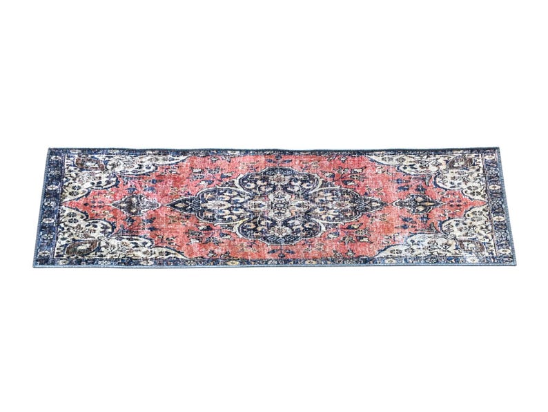 a large, rectangular rug with a floral pattern in shades of red, blue, and white.