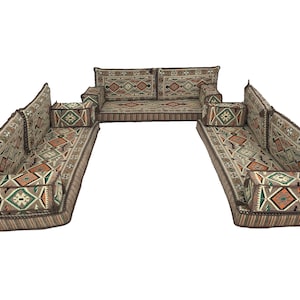 May include: A traditional floor seating set with a U-shaped configuration. The set features a large, rectangular center piece and two smaller, rectangular side pieces. The cushions are covered in a beige fabric with a geometric pattern in shades of brown, orange, and green.
