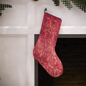 Set of 4 handmade vintage-style Christmas stockings, including red, beige floral, and a traditional red and blue Turkish kilim print, hanging on a fireplace mantel.