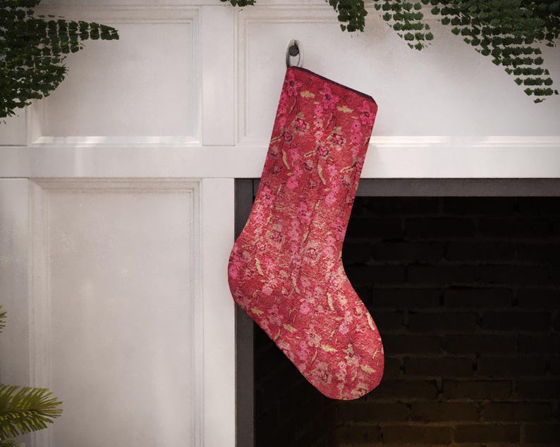Set of 4 handmade vintage-style Christmas stockings, including red, beige floral, and a traditional red and blue Turkish kilim print, hanging on a fireplace mantel.