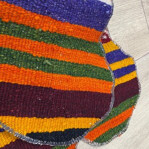 Handmade colorful Turkish Kilim pet mats, boho upcycled rug designed for pets, unique bone-shaped feeding mat, durable woven fabric, eco-friendly recycled carpet, decorative home accent, vibrant patterns and textures, comfortable and easy-to-clean, perfect for indoor or outdoor use, adds charm to any pet feeding area, ideal gift for pet lovers, artisanal inspired Turkish weave, stylish addition to pet space, one-of-a-kind handmade design.