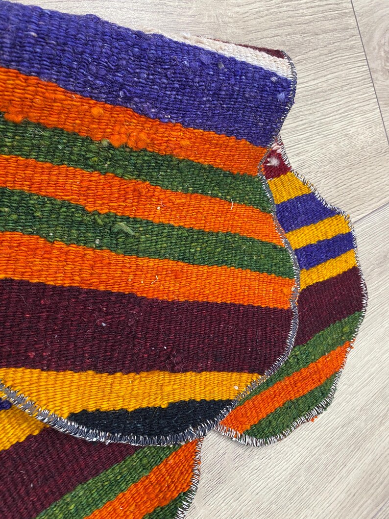 Handmade colorful Turkish Kilim pet mats, boho upcycled rug designed for pets, unique bone-shaped feeding mat, durable woven fabric, eco-friendly recycled carpet, decorative home accent, vibrant patterns and textures, comfortable and easy-to-clean, perfect for indoor or outdoor use, adds charm to any pet feeding area, ideal gift for pet lovers, artisanal inspired Turkish weave, stylish addition to pet space, one-of-a-kind handmade design.