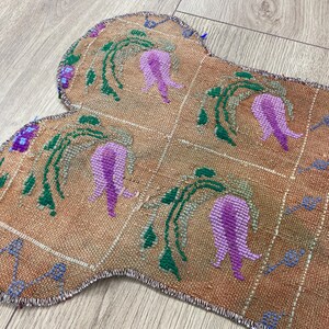 Handmade colorful Turkish Kilim pet mats, boho upcycled rug designed for pets, unique bone-shaped feeding mat, durable woven fabric, eco-friendly recycled carpet, decorative home accent, vibrant patterns and textures, comfortable and easy-to-clean, perfect for indoor or outdoor use, adds charm to any pet feeding area, ideal gift for pet lovers, artisanal inspired Turkish weave, stylish addition to pet space, one-of-a-kind handmade design.