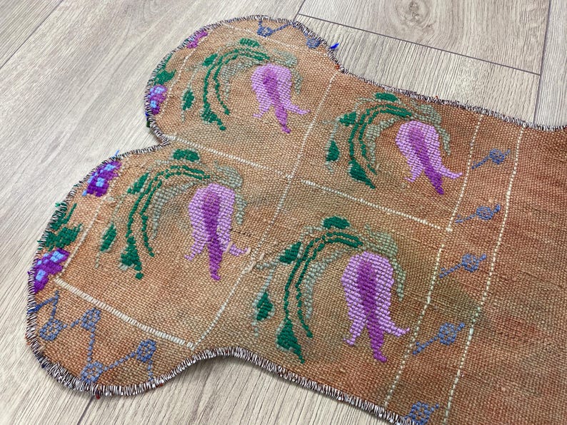 Handmade colorful Turkish Kilim pet mats, boho upcycled rug designed for pets, unique bone-shaped feeding mat, durable woven fabric, eco-friendly recycled carpet, decorative home accent, vibrant patterns and textures, comfortable and easy-to-clean, perfect for indoor or outdoor use, adds charm to any pet feeding area, ideal gift for pet lovers, artisanal inspired Turkish weave, stylish addition to pet space, one-of-a-kind handmade design.