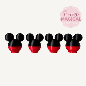 May include: Four black and red Mickey Mouse head bottle stoppers.  The stoppers are made of a smooth, glossy material.