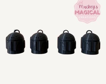 May include: Four black plastic ornaments shaped like helmets. The helmets have a raised design and are approximately 2 inches tall.