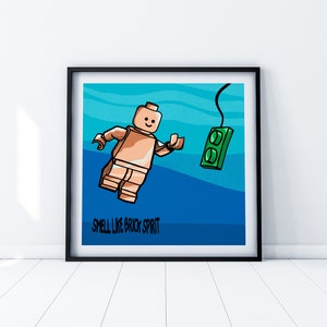 May include: A cartoon illustration of a Lego minifigure floating in blue water with a green Lego brick. The text "Smell like brick spirit" is below the minifigure.