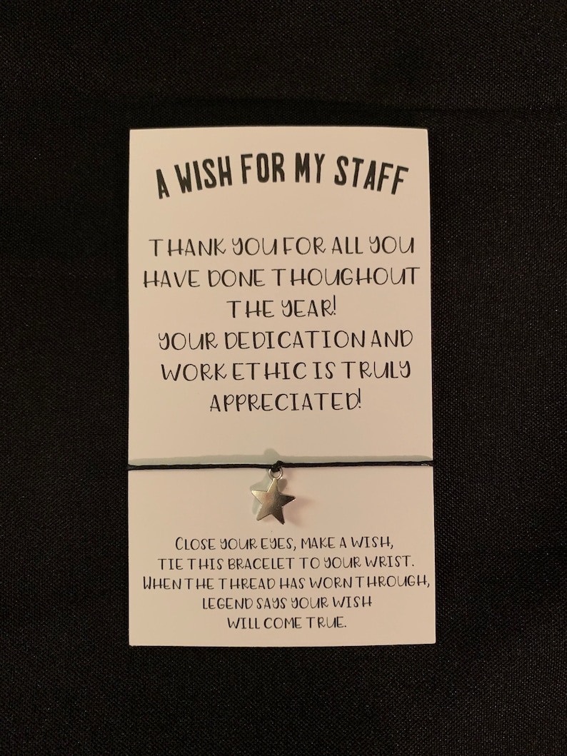 May include: A white card with black text that reads "A Wish for My Staff" and "Thank you for all you have done throughout the year! Your dedication and work ethic is truly appreciated!"  The card also has a silver star charm attached to a black string.