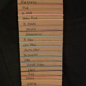 May include: A brown card with a list of colors and their corresponding string colors. The colors are: Magenta, Pink, It. Pink, baby Pink, H. Purple, Purple, Aquamarine, H. blue, Sky blue, dusty blue, thrquoise, blue, Royal blue, Navy, Red, Peach, orange.