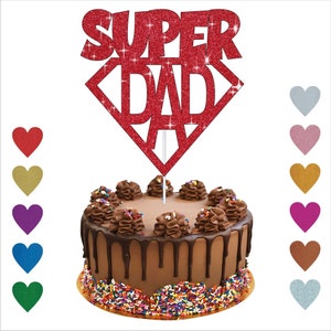 May include: Red glitter cake topper with the words "SUPER DAD" in a diamond shape. The topper is on top of a chocolate cake with sprinkles.