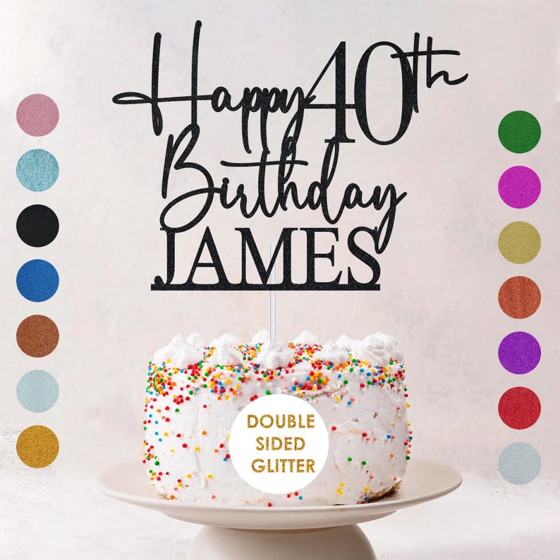 May include: A black glitter cake topper that reads "Happy 40th Birthday JAMES". The topper is placed on a white frosted cake with colorful sprinkles. The words "DOUBLE SIDED GLITTER" are also visible.