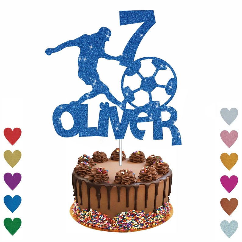 A cake with a soccer ball-shaped topper, and the name "OLIVER" written on it. The cake is decorated with chocolate frosting and sprinkles.