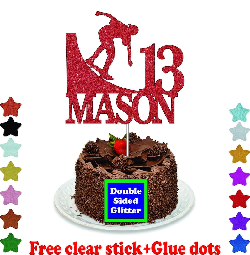 A chocolate cake with a red glittery topper that says "MASON" and a red skateboard silhouette. The cake is placed on a white plate, and there are colorful star-shaped decorations surrounding it.