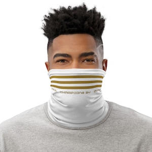 May include: White face mask with gold stripes and the text "Champions 34" printed on it.