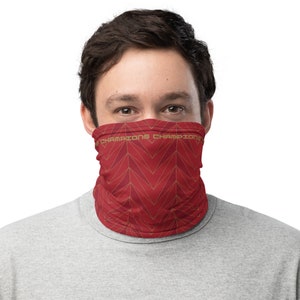 May include: A red face mask with a geometric pattern and the text "Champions Champions" repeated around the edge.
