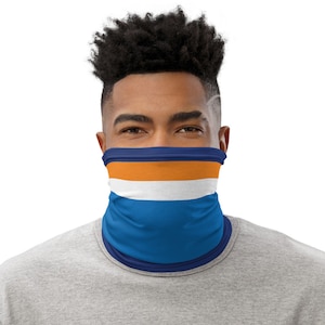 May include: A blue, white, and orange neck gaiter with a striped pattern. The neck gaiter is worn by a person with short, dark hair.