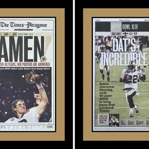 Puede incluir: Dos portadas de periódicos, una con el titular "¡AMEN!" y la otra con el titular "¡DAT'S INCREDIBLE!" Ambas páginas muestran la victoria de los New Orleans Saints en el Super Bowl XLIV.