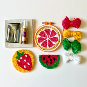 May include: A punch needle kit with colorful embroidery floss, a needle, and a hoop. The kit includes designs for a watermelon, a strawberry, and a grapefruit.
