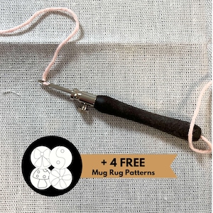 May include: A close-up of a crochet hook and pink yarn on a white canvas fabric. A black circle with four white designs is in the lower left corner. A brown ribbon with the text " + 4 FREE Mug Rug Patterns" is in the lower center.