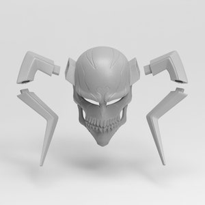 May include: A gray, skull-shaped mask with detached angular pieces. The mask features a detailed skull design with visible teeth and eye sockets. The detached pieces are geometric and angular, suggesting a modular or assembled design. The mask is likely for cosplay or costume use.