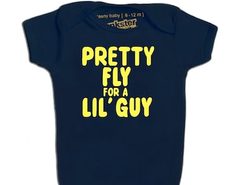 May include: A navy blue baby onesie with yellow text that reads "Pretty Fly For A Lil' Guy".