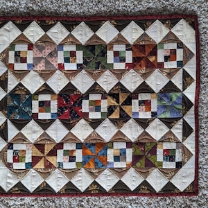 May include: A set of three ceramic mugs with a speckled, matte finish. The mugs are in shades of cream, light gray, and dark gray. Each mug has a simple, modern design and a rounded handle. The mugs are stacked on top of each other.