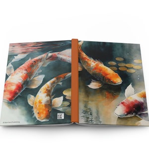 May include: Open journal featuring a watercolor painting of koi fish in shades of orange, white, and red swimming in a pond. The journal has a brown spine and the text "Barnyard Publishing" is visible.