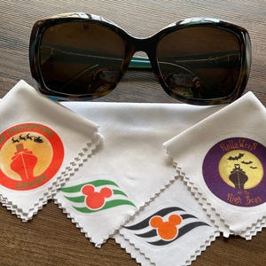 May include: Sunglasses with a tortoise shell pattern frame and dark lenses. Includes several white cleaning cloths with colorful circular designs featuring a cruise ship, Mickey Mouse, and Halloween themes.
