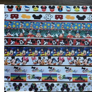 May include: A collection of various ribbons featuring Mickey Mouse and Disney-themed designs. The ribbons display colorful patterns with Mickey Mouse, Minnie Mouse, and other Disney characters. Some ribbons have the Disney logo.