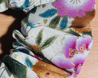 Coletero artesanal de algodón con estampado floral metálico de grullas japonesas.