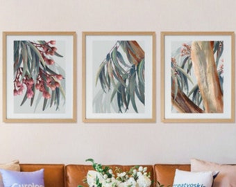 May include: A set of three framed botanical prints featuring a close-up of eucalyptus leaves and branches. The prints are in a light wood frame and have a white background.