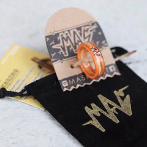 Ring comes in a little black baggie with our tag screen printed in golden ink.
attached is our card along with an instruction card. 

Keep a piece of skateboarding always with you.