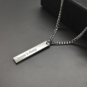 May include: A silver chain necklace with a silver bar pendant that says "Forever & Always".