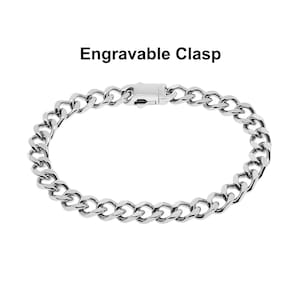 May include: A silver chain bracelet with an engravable clasp. The chain is made of a thick, durable metal.