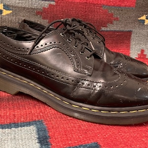 Broken-in and distressed Dr. Martens Smooth Black Leather Brogue Wingtip Oxfords US MENS size 10 (UK size 9)