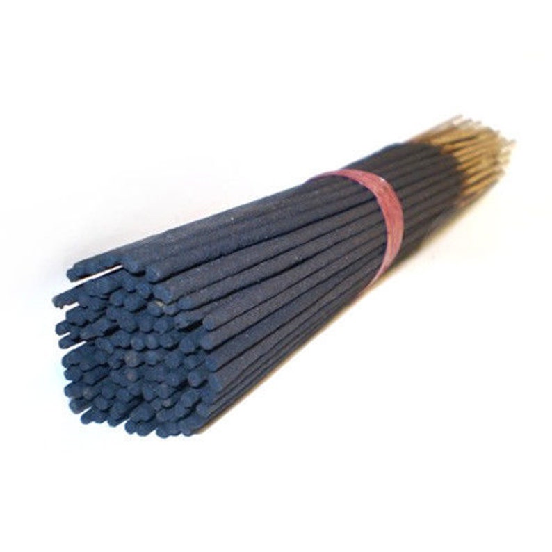 May include: A bundle of black incense sticks tied together with a red rubber band. The sticks are approximately 10 inches long.